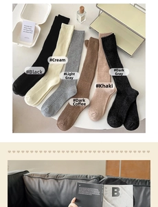Flat lay of ribbed knit knee-high socks in six autumn colors with lifestyle props