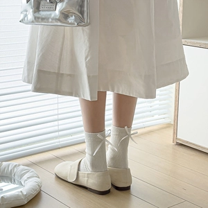 Cream white mid-calf ribbed socks with delicate bow detail and Mary Jane shoes