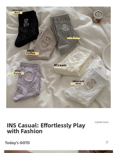 Flat lay of six colorful mid-calf socks with cute 3D bear patterns in soft tones