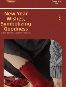 Close-up of red knit crew socks with festive wavy lettuce edge cuffs for New Year wear