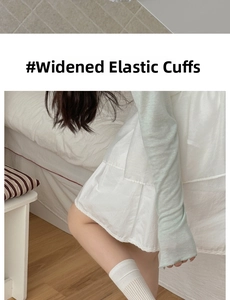Detail of white cotton crew socks showing the wide elasticated cuff in a cozy setting