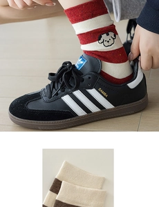 Detail of red striped cotton socks with cute cartoon dog embroidery and ribbed cuffs
