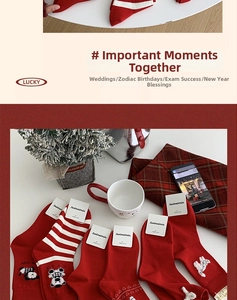 Close-up of festive red cotton socks collection with white patterns and animal motifs