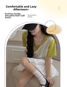 Detailed view of white cotton knit calf socks styled with an embroidered lace skirt