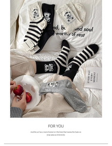 Close-up of knit cotton socks featuring cute bear patterns and striped textures