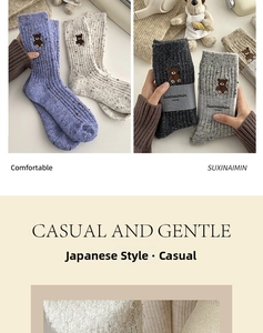 Détail de chaussettes en laine tricotée avec broderie ours en violet et tons d'automne