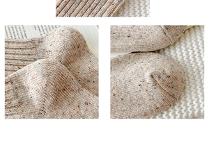 Detail of wool blend socks with flecked yarn texture and vertical knit ribbing