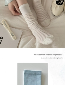 Detail of ribbed knit texture on cream and light blue cotton crew socks for women