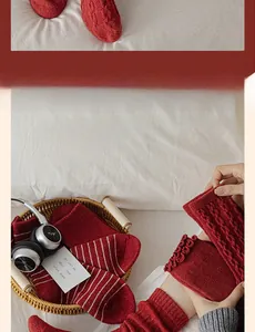 Close-up of red cable knit wool socks featuring striped patterns and scalloped cuffs