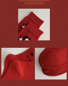 Close-up of red New Year cotton socks featuring panda prints and ribbed cuffs details