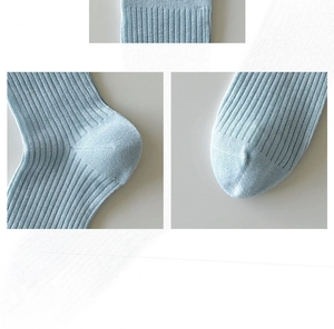 Close-up of light blue rib-knit socks detailing reinforced heel and toe construction