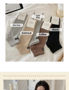 Flat lay of ribbed mid-calf knit socks in black, coffee, grey, and oatmeal colors