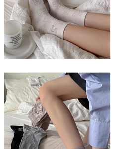 Detailed view of knitted cotton socks with cute bear embroidery in beige and grey