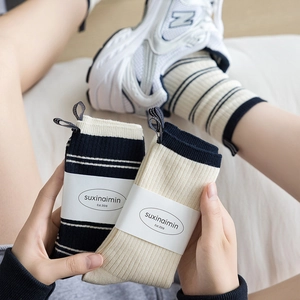 Mid-calf cotton knit socks with striped patterns and ribbed texture for a casual look