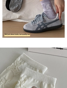 Detail of cute bear pattern jacquard on cotton mid-calf socks shown with casual sneakers