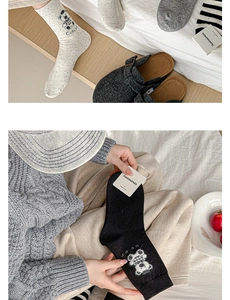 Detail of cotton crew socks featuring cute bear embroidery and striped pattern design