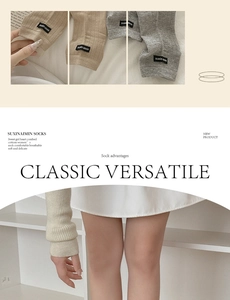 Detail of knitted leg warmers in cream and grey featuring vertical stripe texture