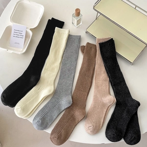 Maillard style ribbed knee-high socks in six colors laid on table for autumn winter