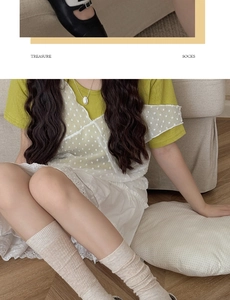 Detailed view of oatmeal ribbed mid-calf socks styled with a Japanese lace skirt