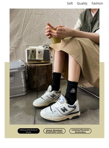 Detail of soft cotton crew socks with camping mountain embroidery and breathable texture