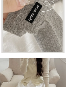 Detail of suxin ainin brand label on knitted cardigan cuffs with buttons