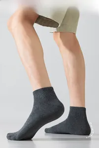 Detail of dark grey cotton ankle socks featuring ribbed cuffs and anti-slip heel design