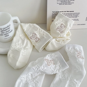 White crew socks with cute bear embroidery and textured knit pattern for casual wear