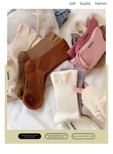 Close-up of colorful ribbed knit cotton slouch socks in warm autumn tones