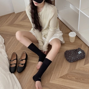 Minimalist black leg warmers styled with Mary Jane shoes for a chic Korean look