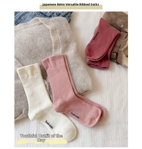 Detail showing high-quality vertical rib knit texture on minimalist cotton slouch socks