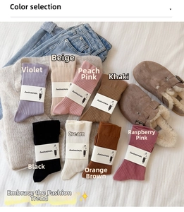Flat lay of colorful ribbed mid-calf cotton socks in eight soft pastel and earthy tones