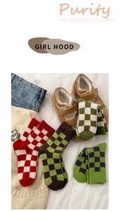 Flat lay of colorful checkered knit wool socks with soft texture for winter warmth