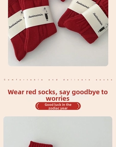 Detail of red knit socks with thick ribbed texture and minimalist brand packaging