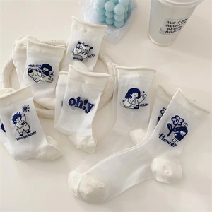 White cotton crew socks with cartoon embroidery and blue ruffles in a set of six
