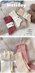 Close-up of wide ribbed elastic cuffs on warm cotton knit slouch socks for women