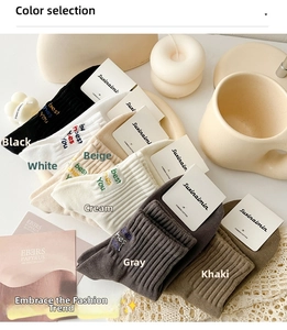 Close-up of ribbed cotton crew socks in six colors with stylish letter embroidery