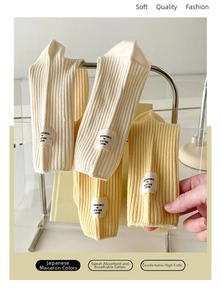 Detailed view of ribbed cotton mid-calf socks with side label in soft macaron tones