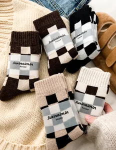 Detail of checkered wool socks with brand paper bands in warm winter setting