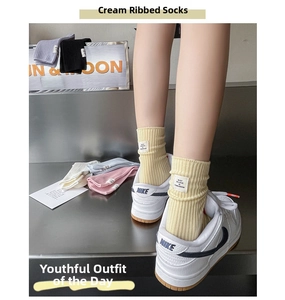 Detail of cotton slouch socks with woven label and colorful knit texture for women