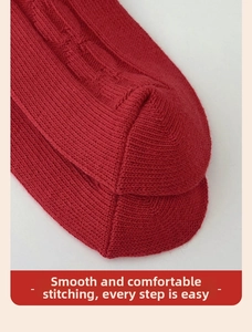 Close-up of red knitted socks showing thick cotton texture and flat toe seam detail