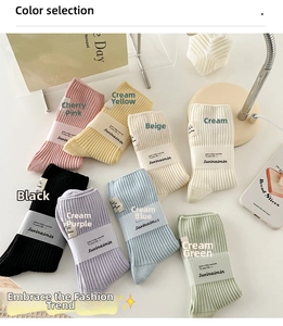 Close-up of ribbed cotton socks in pastel colors with paper branding labels