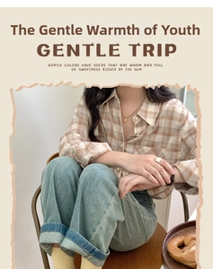 Close-up of yellow mid-calf socks styled with vintage denim and casual shirt