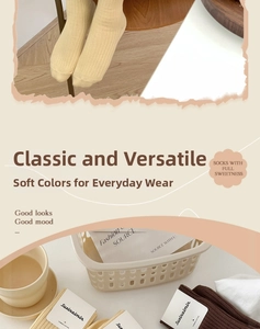 Detailed texture of combed cotton ribbed crew socks in warm beige and brown tones