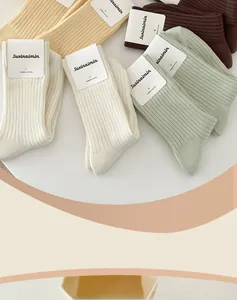 Detail of ribbed combed cotton socks in Morandi tones with clean white packaging card