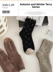 Detailed view of winter thermal socks with polka dots and ruffled edges in neutral tones