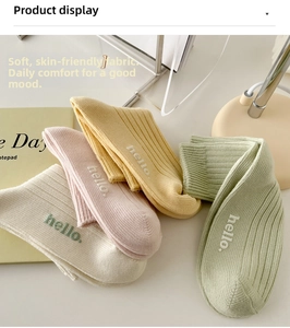 Détail de quatre paires de chaussettes en coton côtelé pastel avec broderie hello