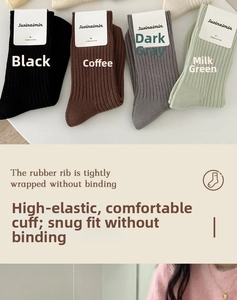 Detailed view of elastic ribbed cuffs on combed cotton mid-calf socks in four neutral colors