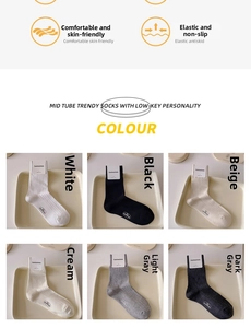 Close-up of six color varieties of ribbed crew socks including cream and grey tones