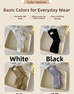 Detail of ribbed mid-calf cotton socks in white, black, khaki and purple with cloth tags