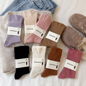 Eight pairs of ribbed cotton slouch socks in various colors arranged in a fan shape layout